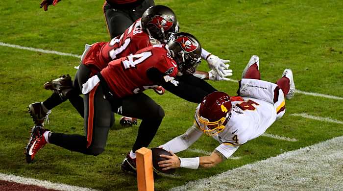 Jan 9, 2021; Landover, Maryland, USA; Washington Football Team quarterback Taylor Heinicke (4) scores a touchdown against the Tampa Bay Buccaneers during the third quarter at FedExField.